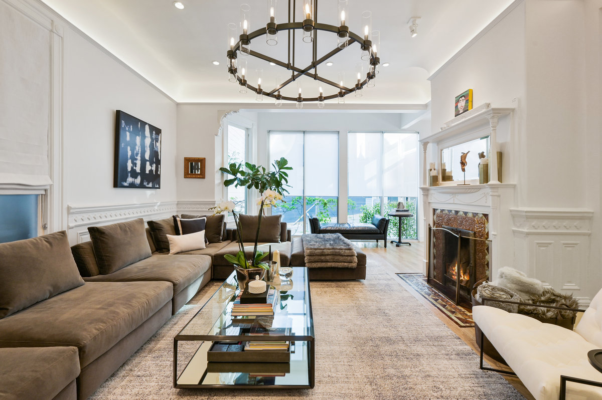 Living room with cove lighting, vintage details and fireplace