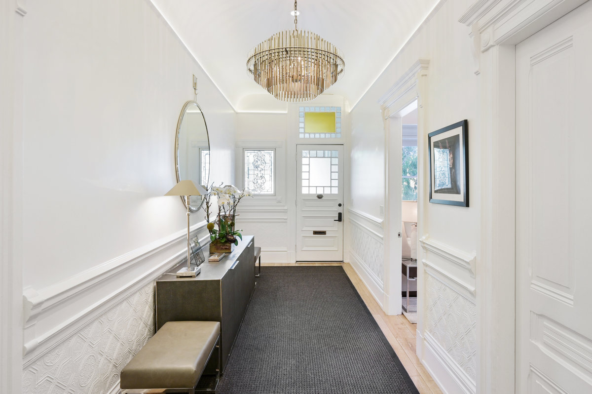 Gracious entry foyer with primary bedroom through doorway on right