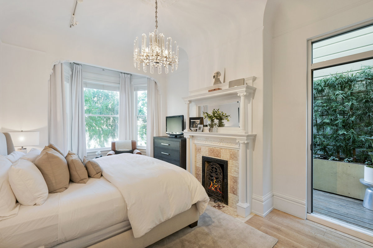 The primary suite with bay window, fireplace and small private deck