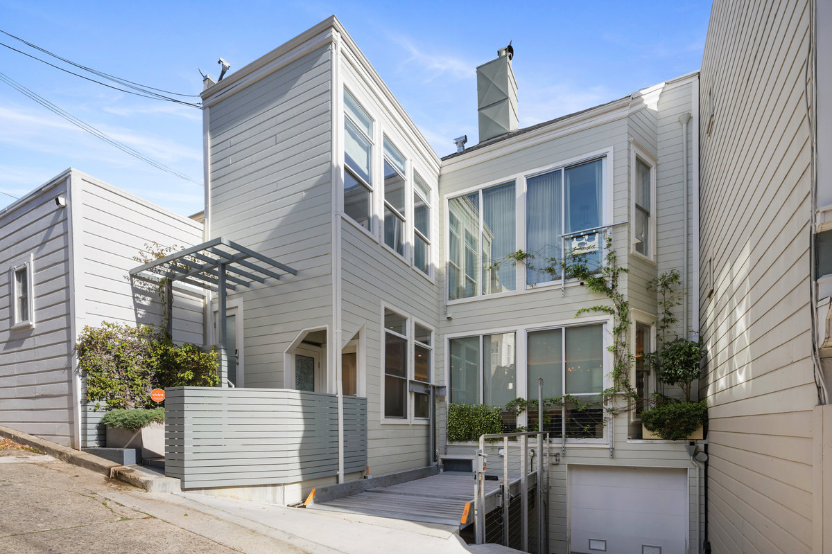 Parking is accessed via Ames Alley to the west behind the house and is a mechanical stacker with the upper, ideal drive-in spot for 990 for easy acces