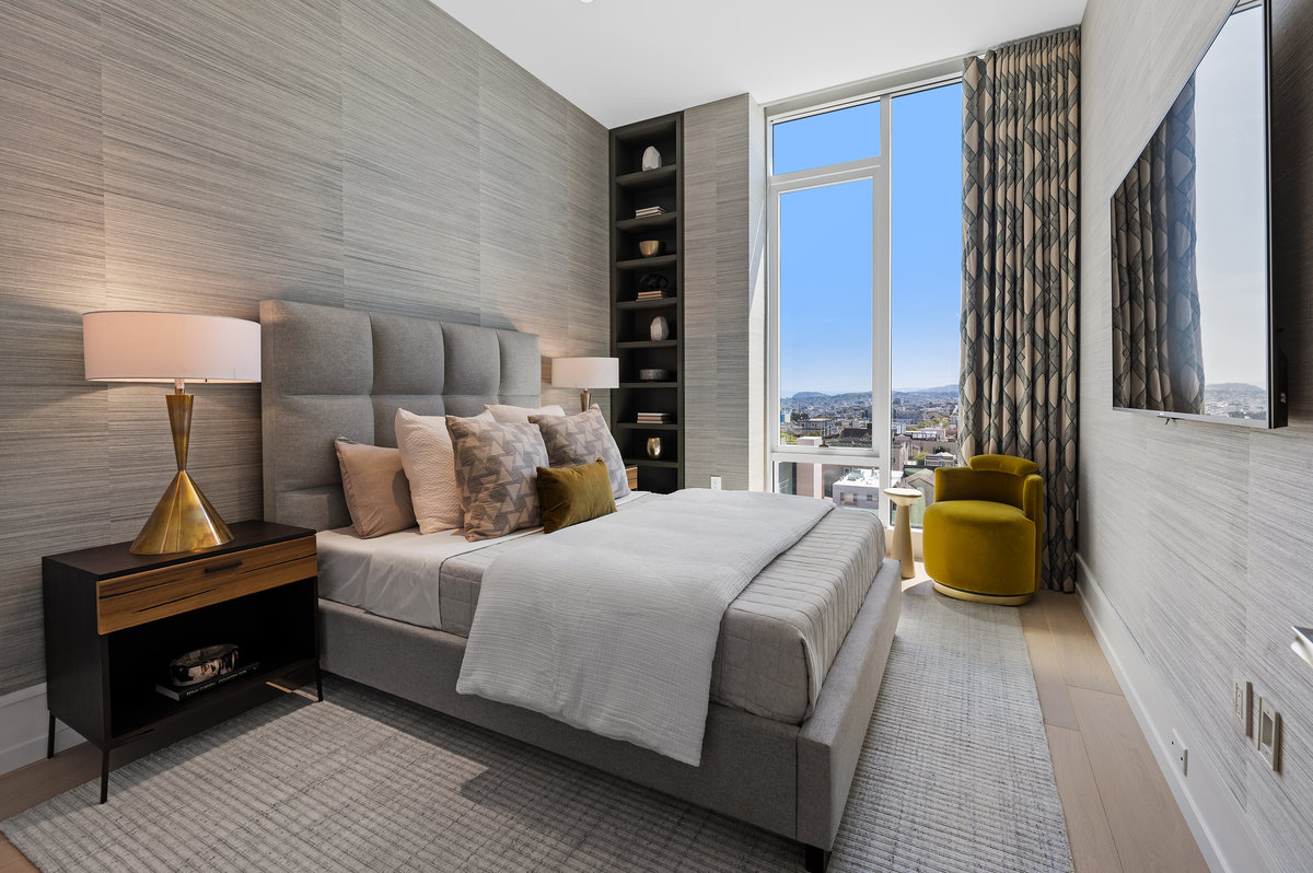 Guest bedroom with custom bookcases, handsome grasscloth wallpaper, custom blackout drapes, flat screen TV. Could alternatively serve as a home office
