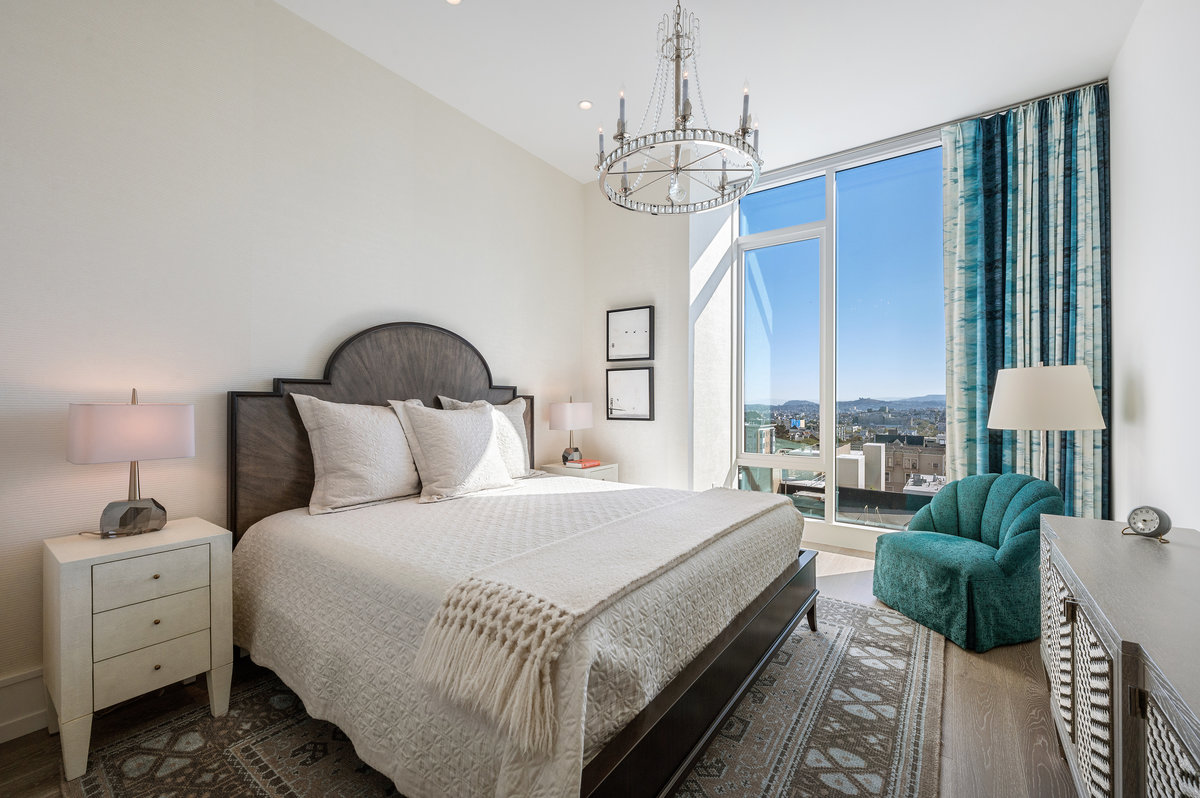 Primary suite faces south; subtle cream colored fabric wallpaper