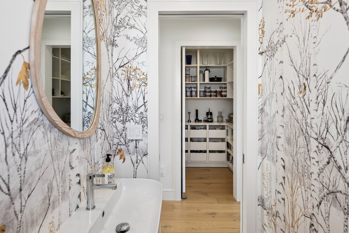 Fun powder room privately tucked off the hall across from pantry