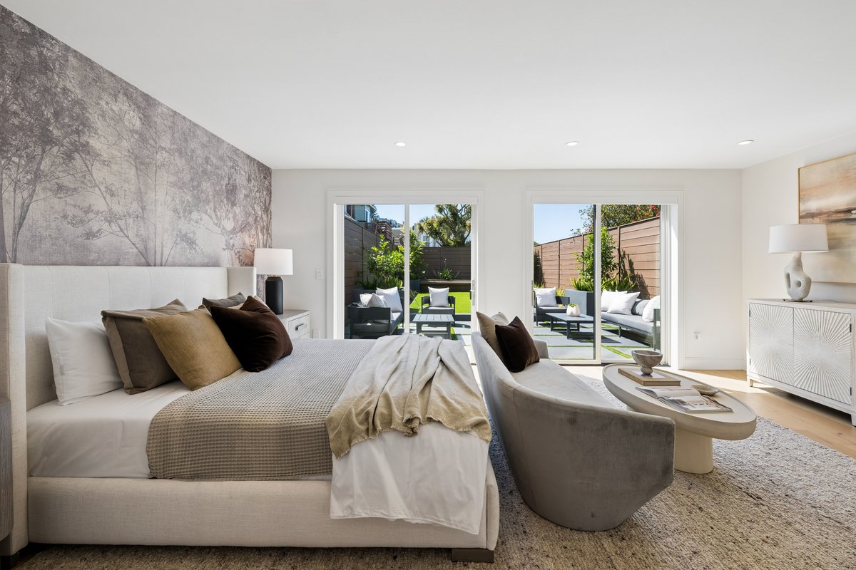 Generous primary suite with plenty of space for a king bed, nightstands, sofa + table seating area and a large dresser