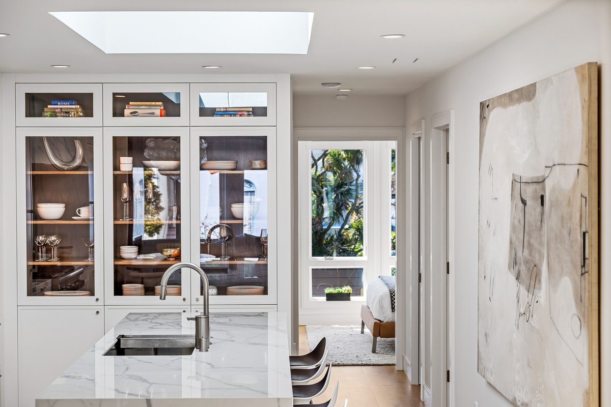 Kitchen display cabinet for your favorites; plenty of seating at the island; rear bedroom window in the background
